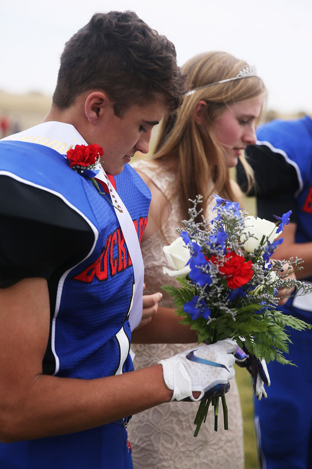 Dylan Fauber hold the flowers for queen Tinley Pierson